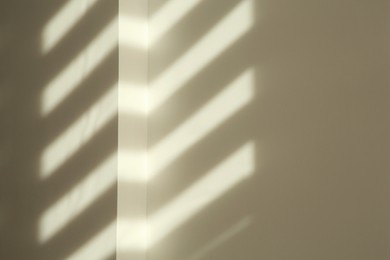 Photo of Lines made of light and shadows on white wall