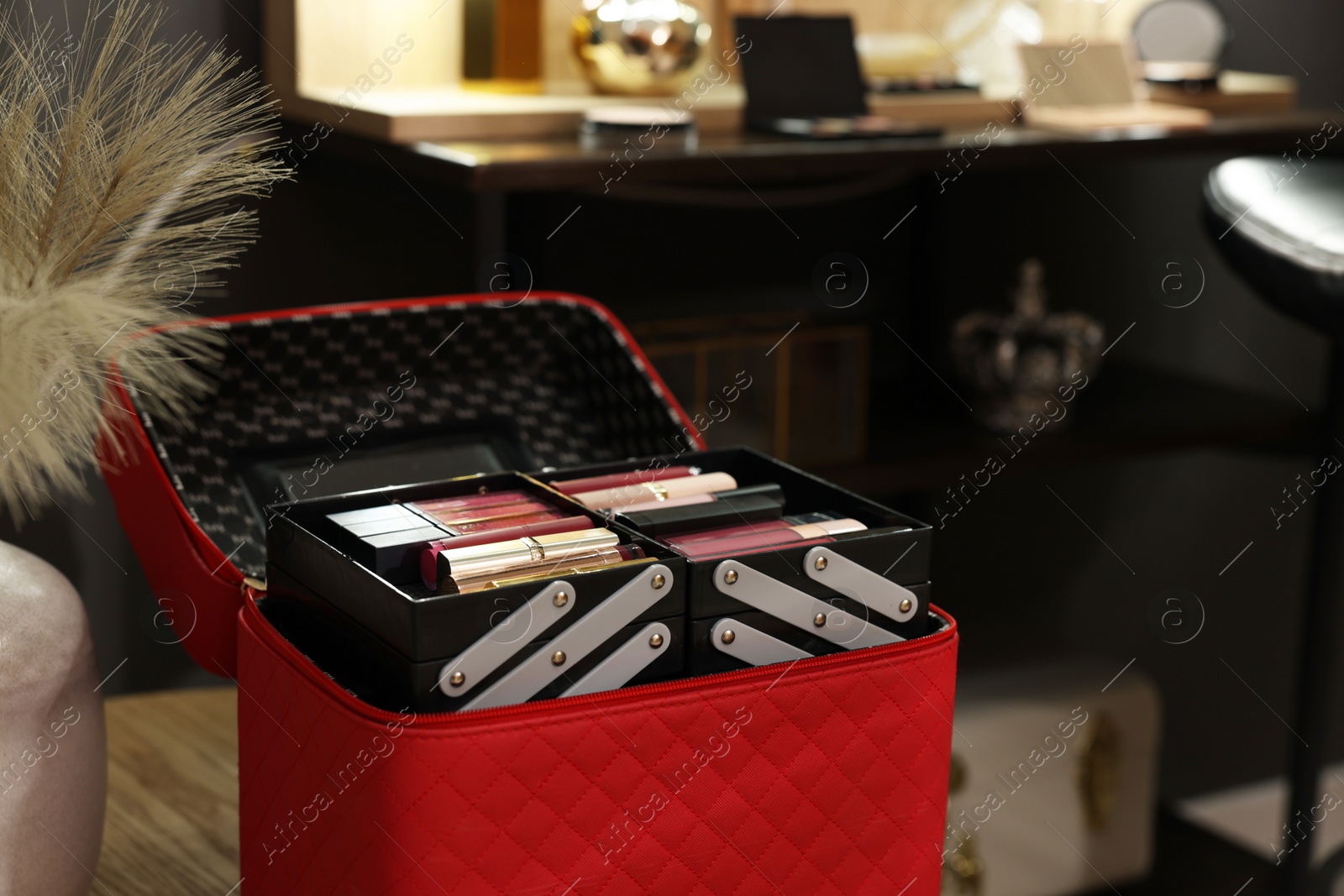 Photo of Beautician case with cosmetic products in makeup room