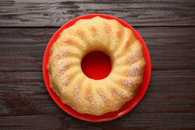 Photo of Delicious freshly baked sponge cake on wooden table, top view