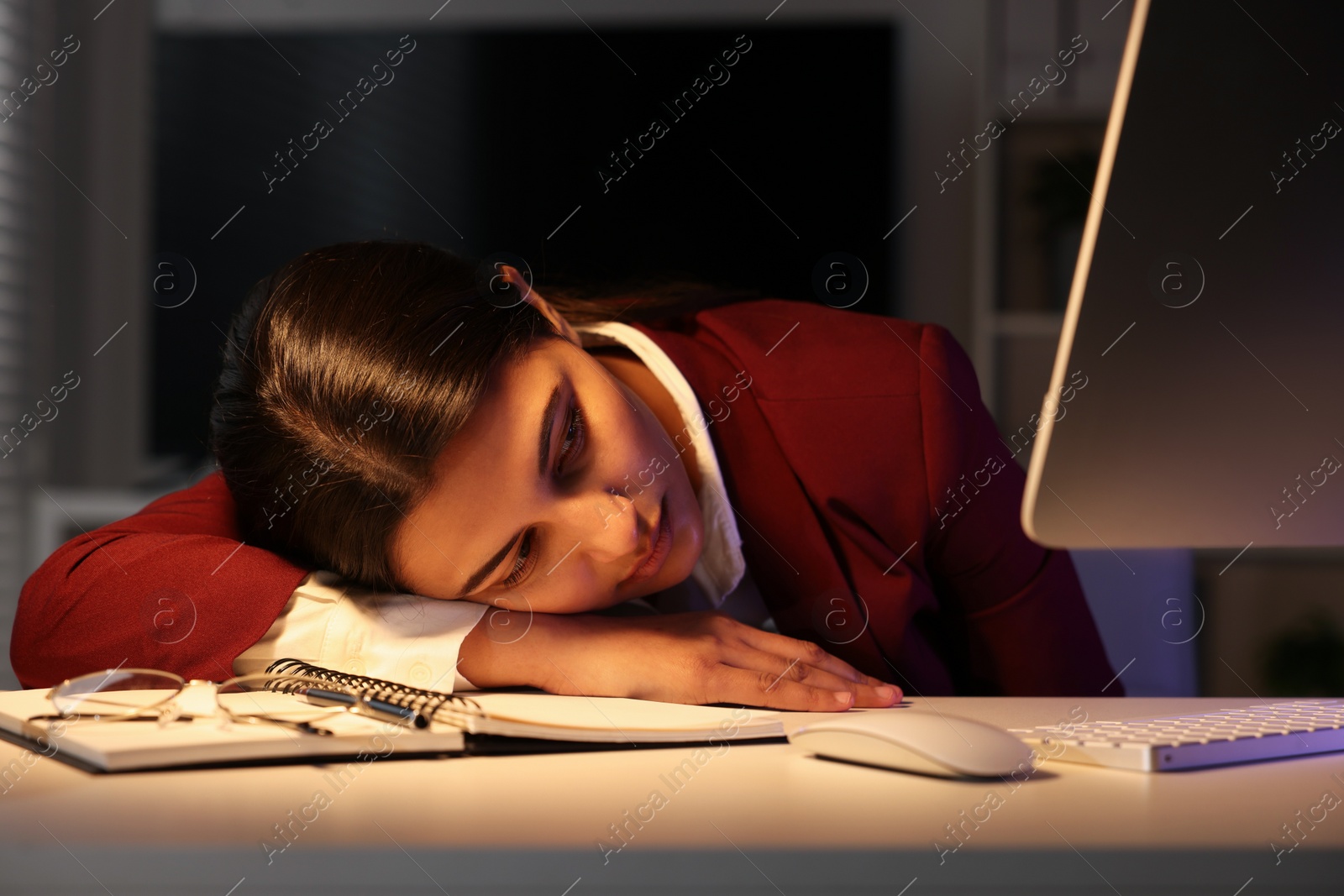 Photo of Tired overworked businesswoman at table in office