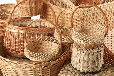 Photo of Many different wicker baskets made of natural material as background