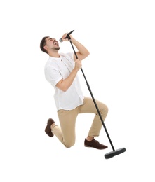 Photo of Young handsome man singing in microphone on white background