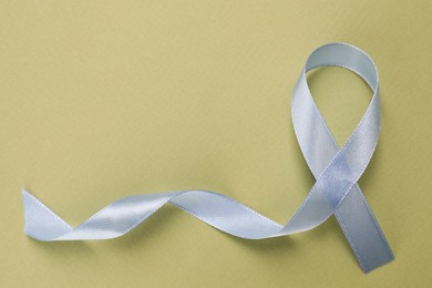Photo of International Psoriasis Day. Ribbon as symbol of support on green background, top view. Space for text