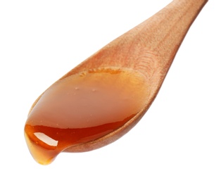 Photo of Honey dripping from spoon on white background