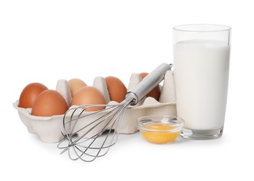 Photo of Metal whisk, raw eggs and glass of milk isolated on white