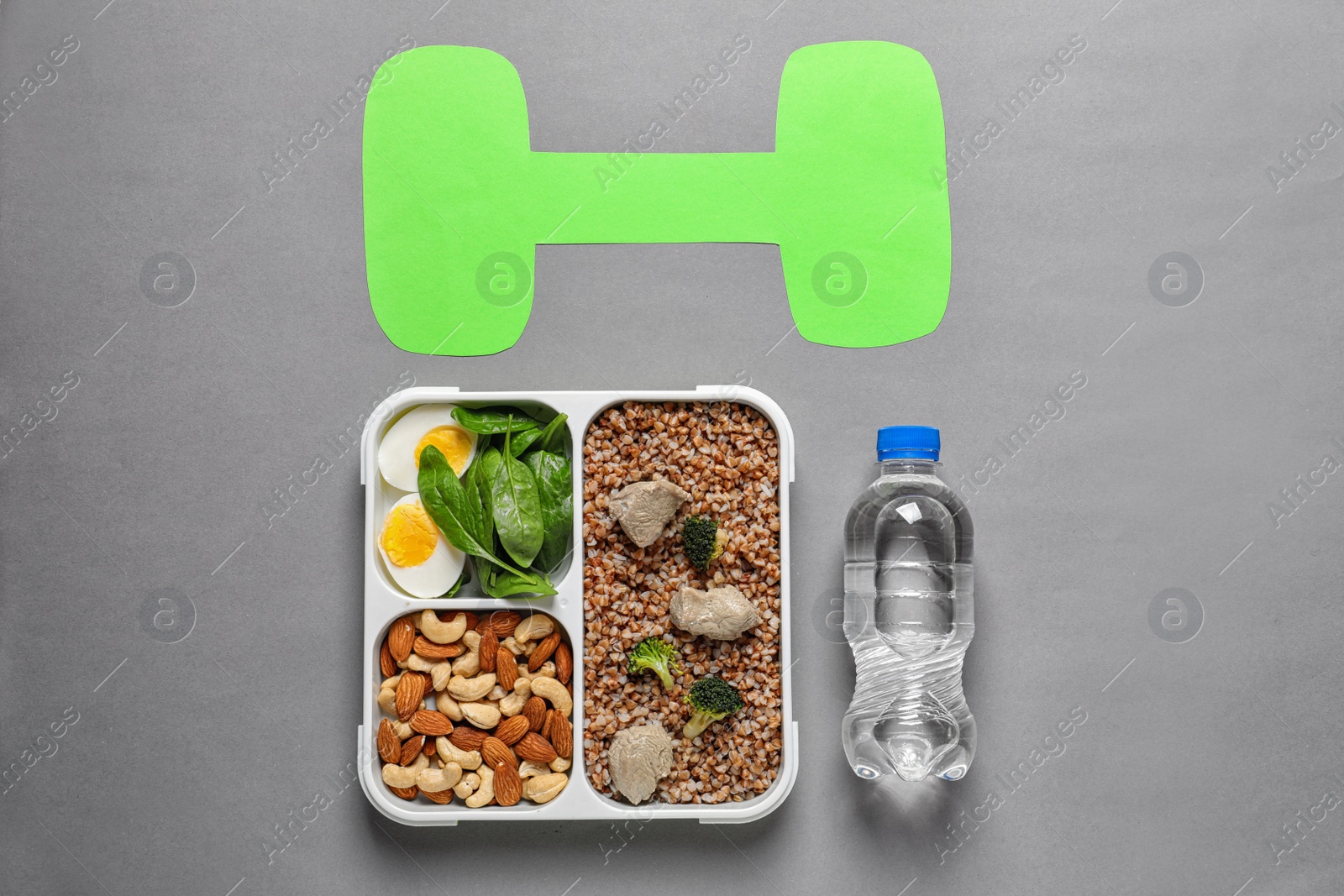 Photo of Flat lay composition with container of natural protein food on gray background