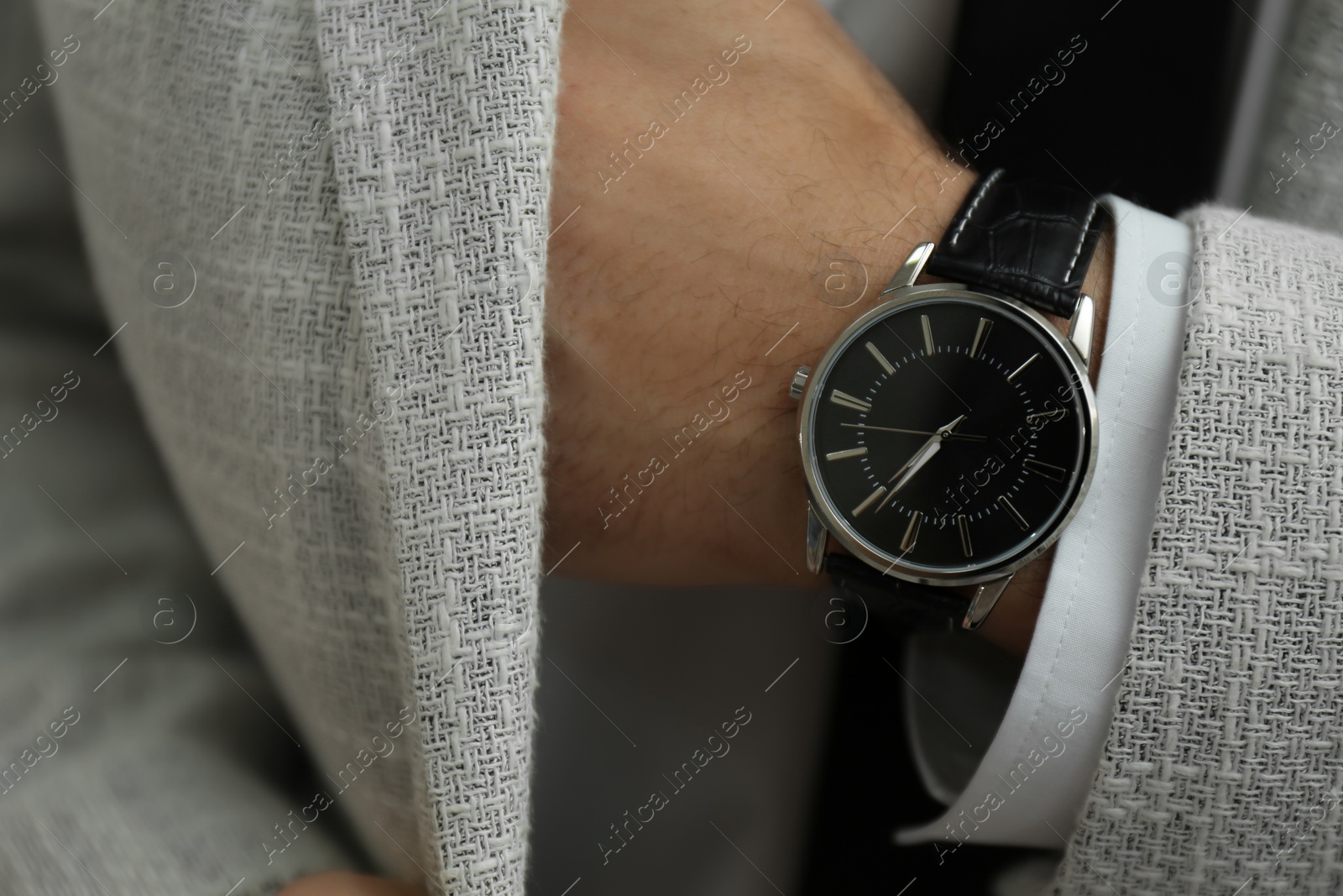 Photo of Businessman in jacket with luxury wrist watch, closeup