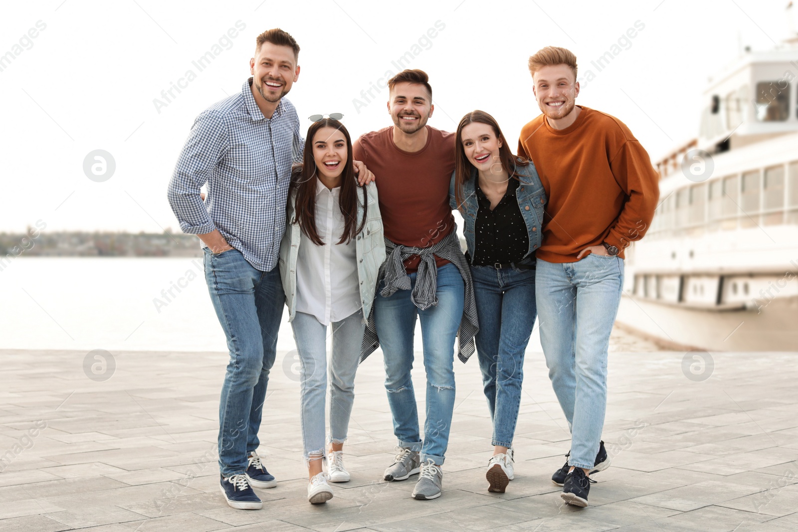 Photo of Group of happy people spending time together at promenade