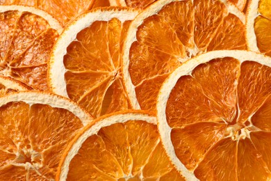 Heap of dry orange slices as background, top view