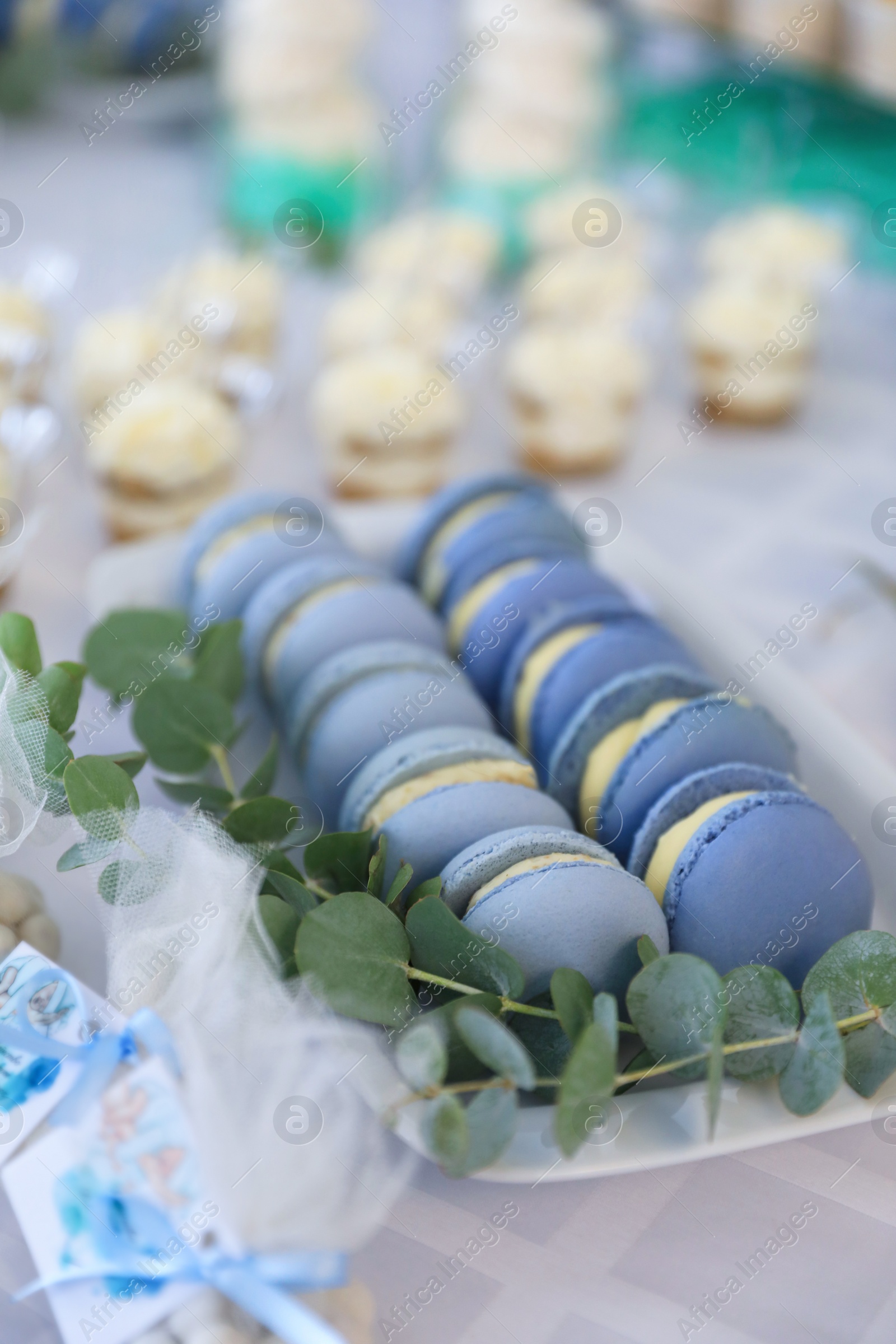 Photo of Delicious sweet blue macarons served on table