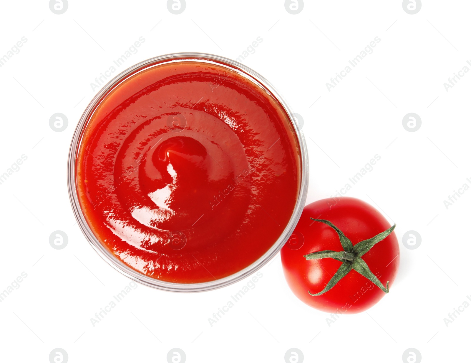 Photo of Tasty homemade tomato sauce in glass and fresh vegetable on white background, top view