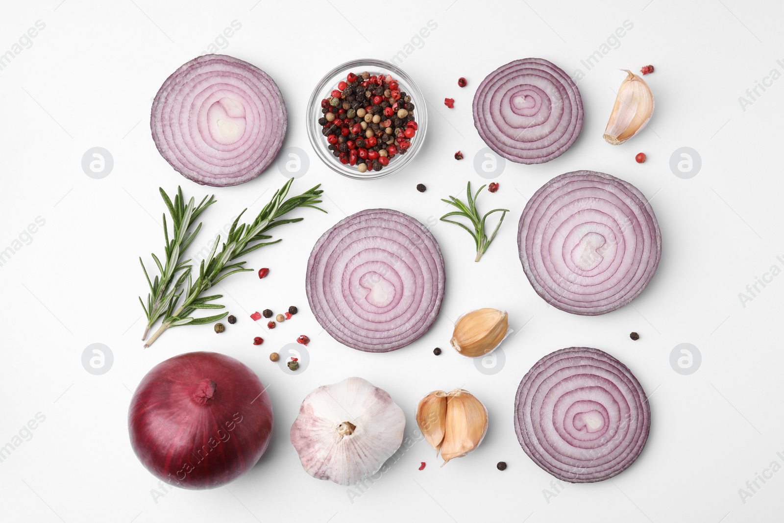 Photo of Fresh red onions, garlic, rosemary and spices on white background, flat lay