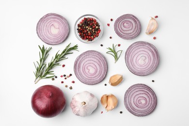 Fresh red onions, garlic, rosemary and spices on white background, flat lay