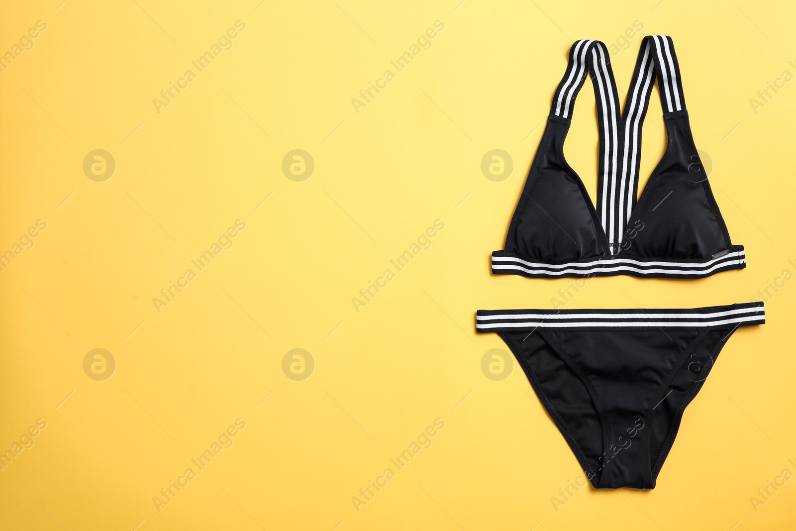 Photo of Stylish bikini on color background, top view