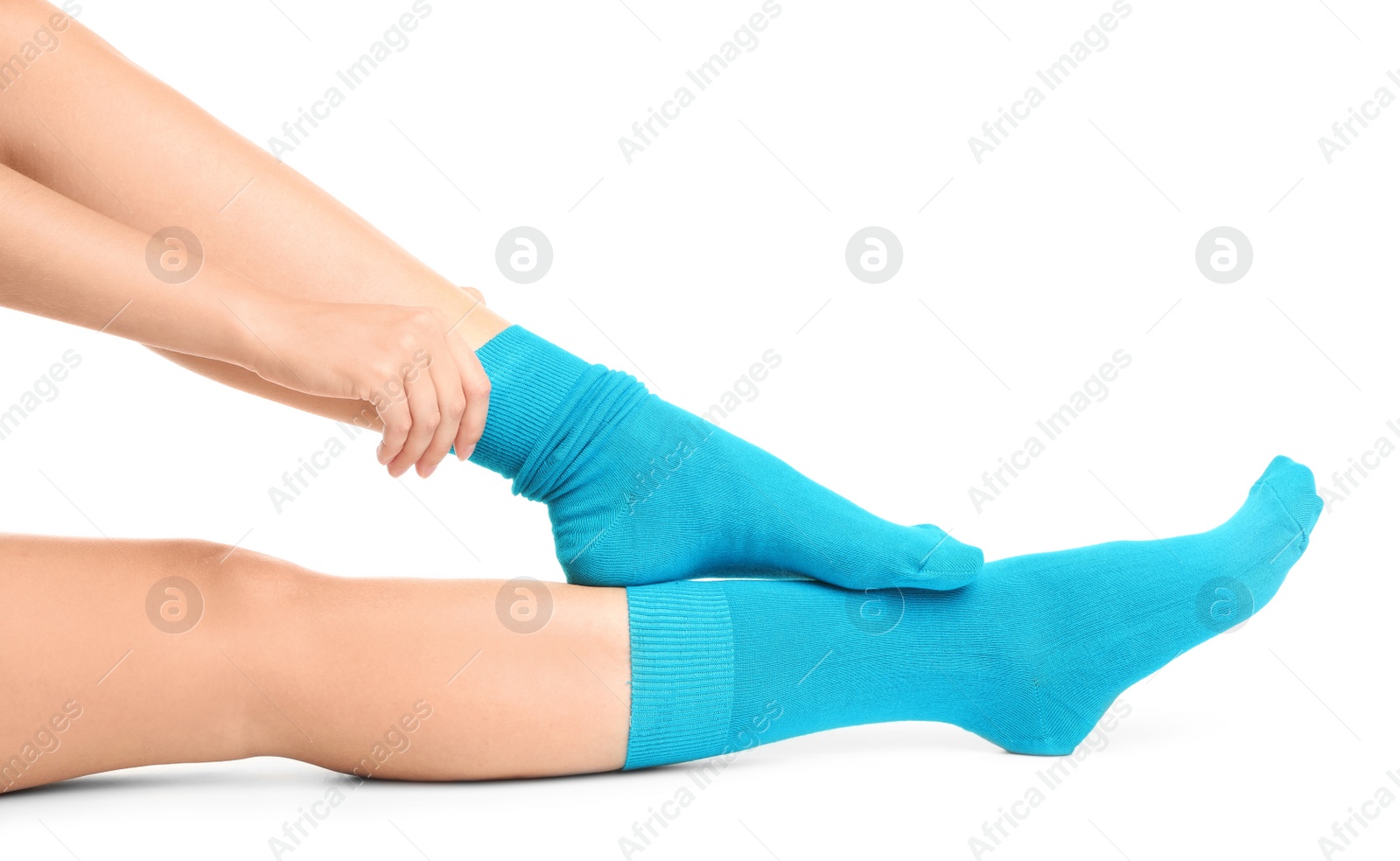 Photo of Woman putting on stylish socks on white background, closeup