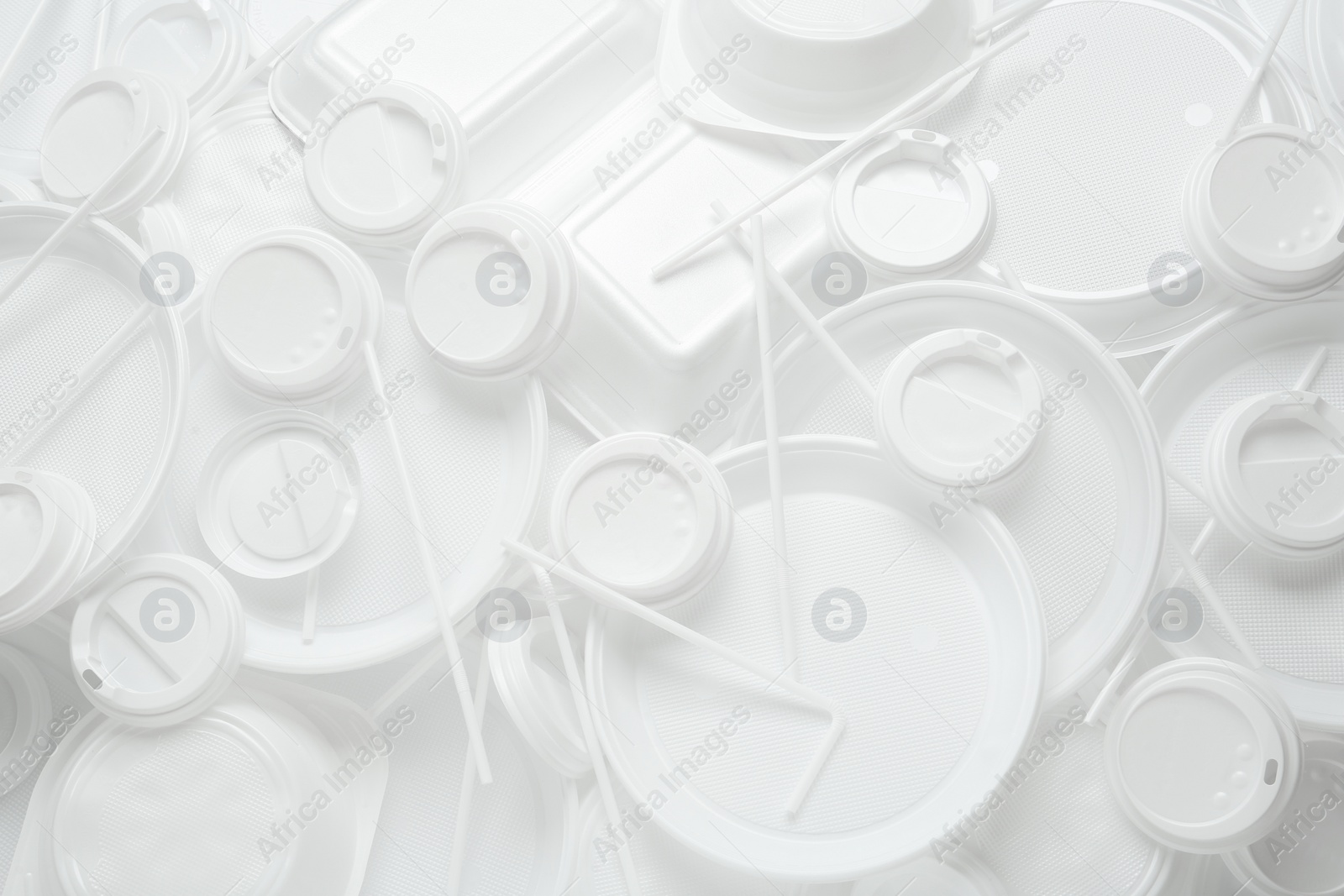 Photo of Different white plastic items as background, closeup