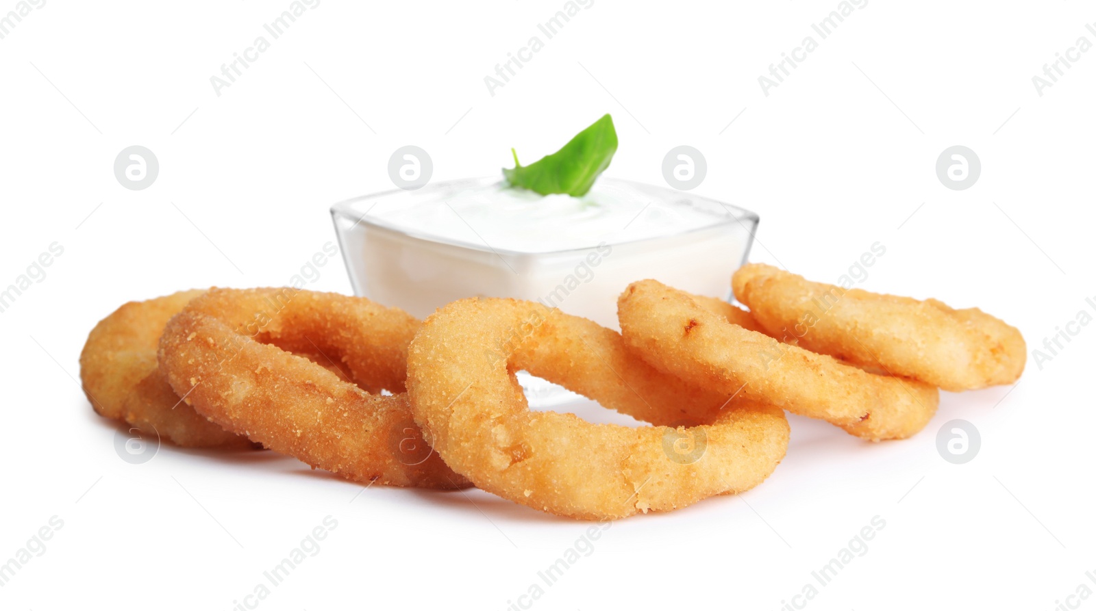 Photo of Delicious onion rings and sauce isolated on white