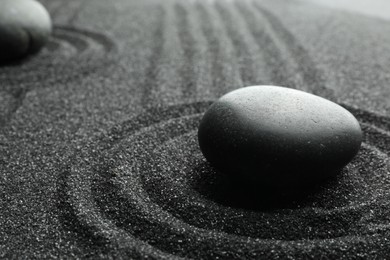 Photo of Black sand with stone and beautiful pattern. Zen concept