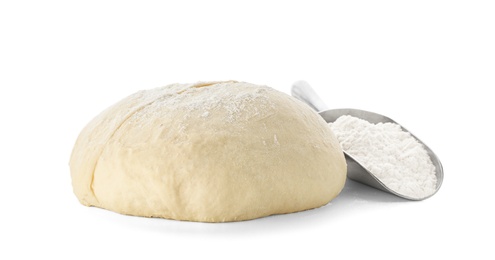 Photo of Raw wheat dough and scoop with flour on white background