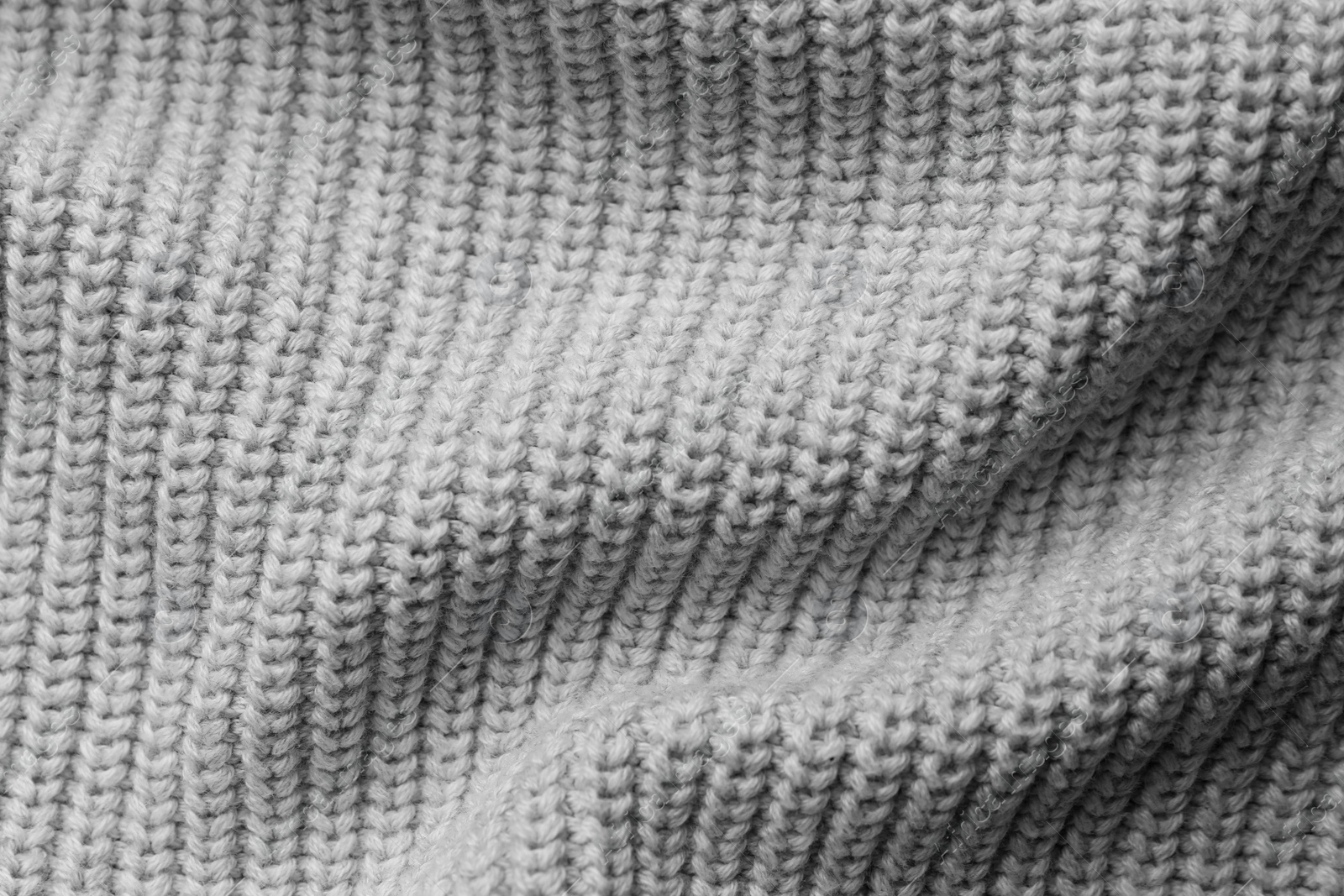 Photo of Grey knitted fabric as background, top view