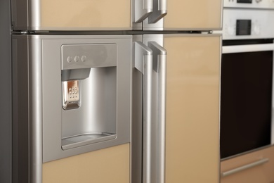 Refrigerator with ice and water system, closeup. Modern kitchen appliance