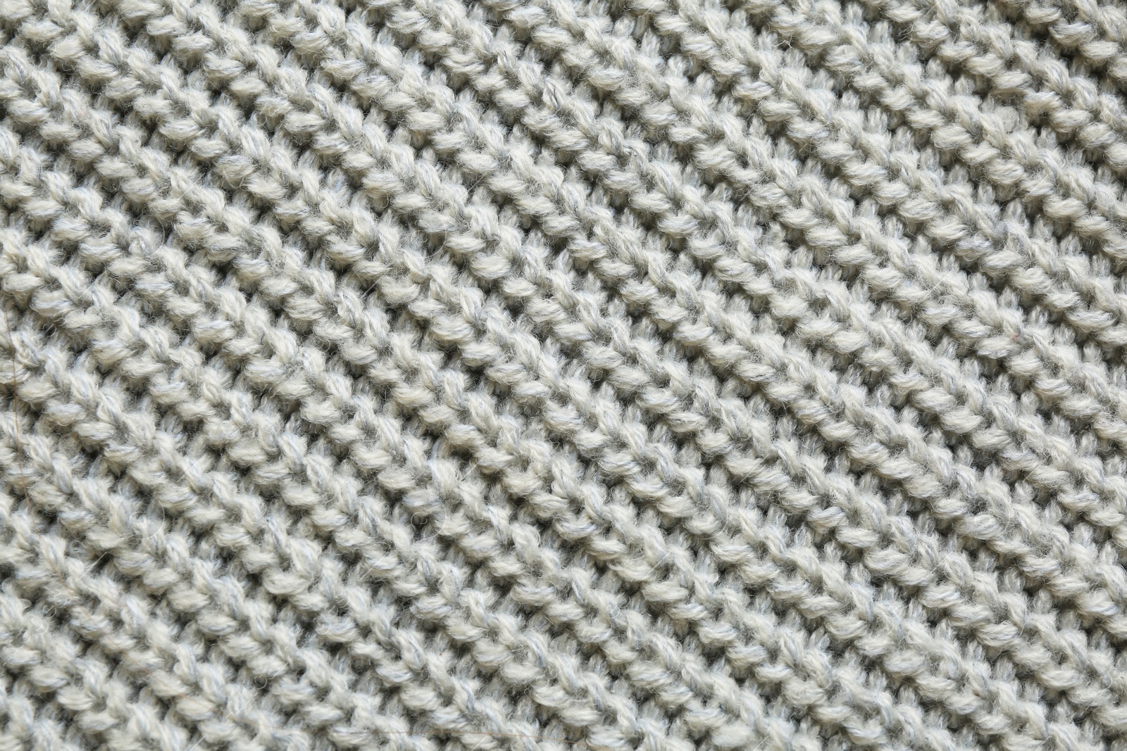 Photo of Beautiful grey knitted fabric as background, top view