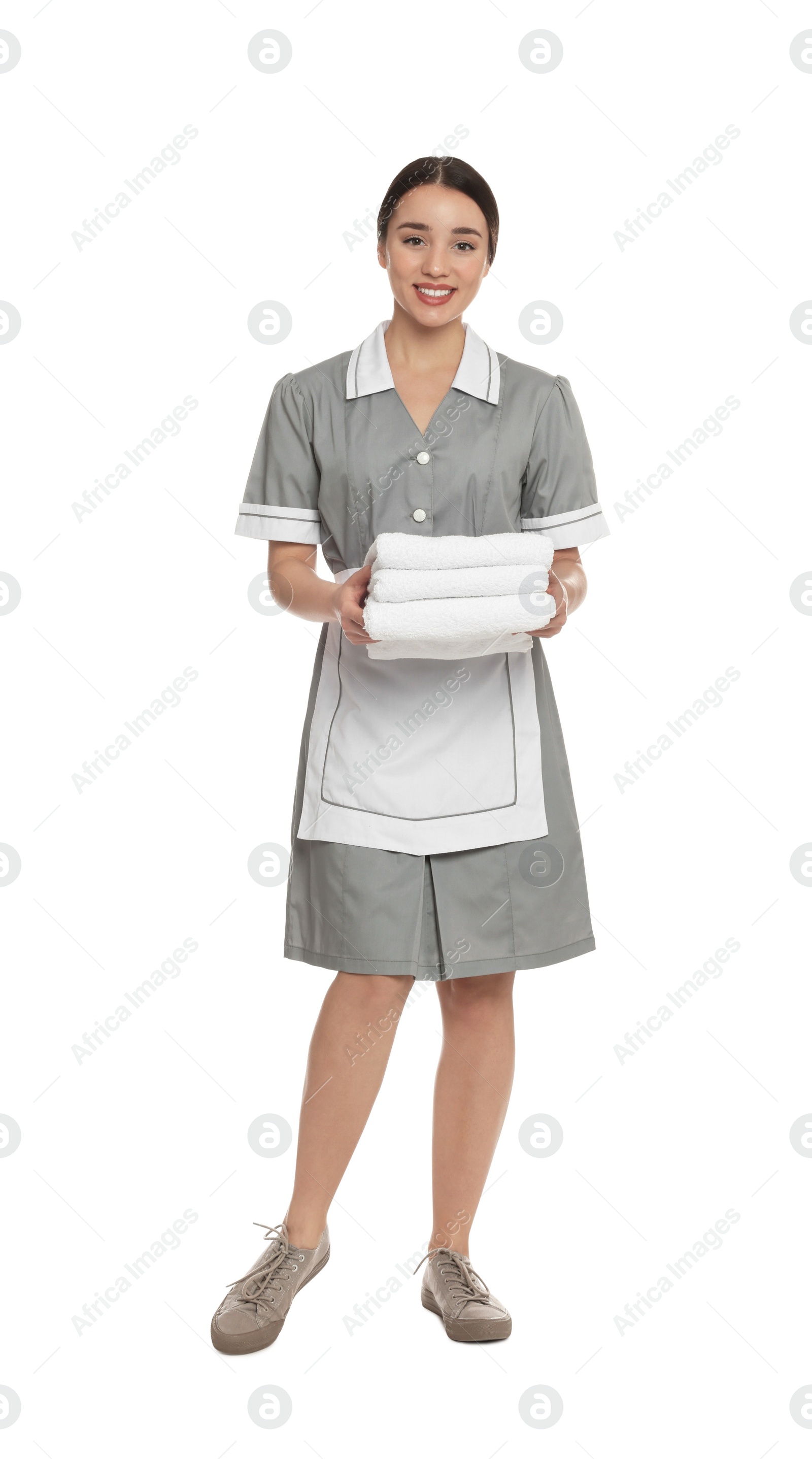 Photo of Full length portrait of young chambermaid with towels on white background