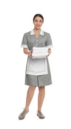 Full length portrait of young chambermaid with towels on white background