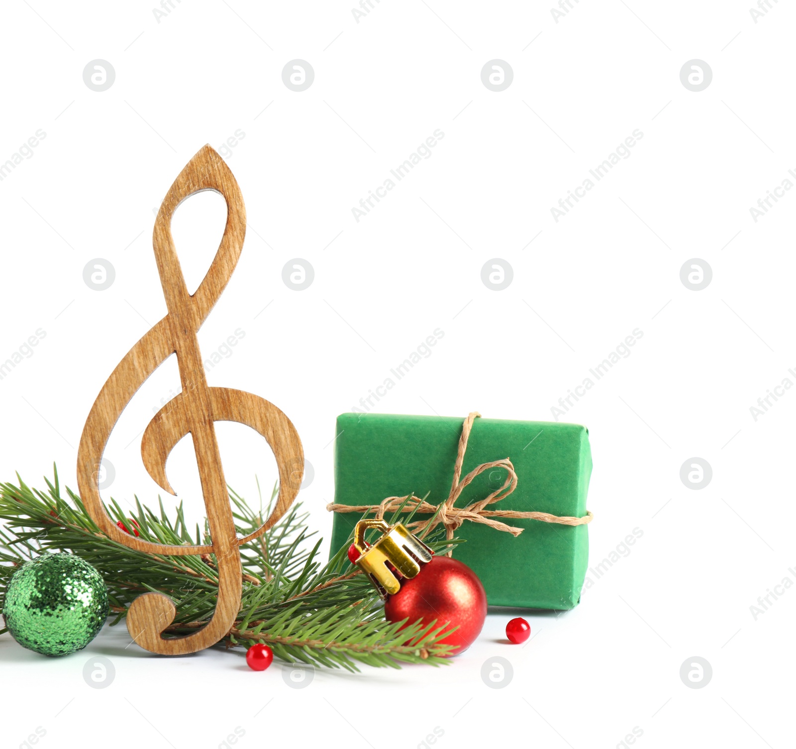 Photo of Treble clef with decorations isolated on white. Christmas music concept