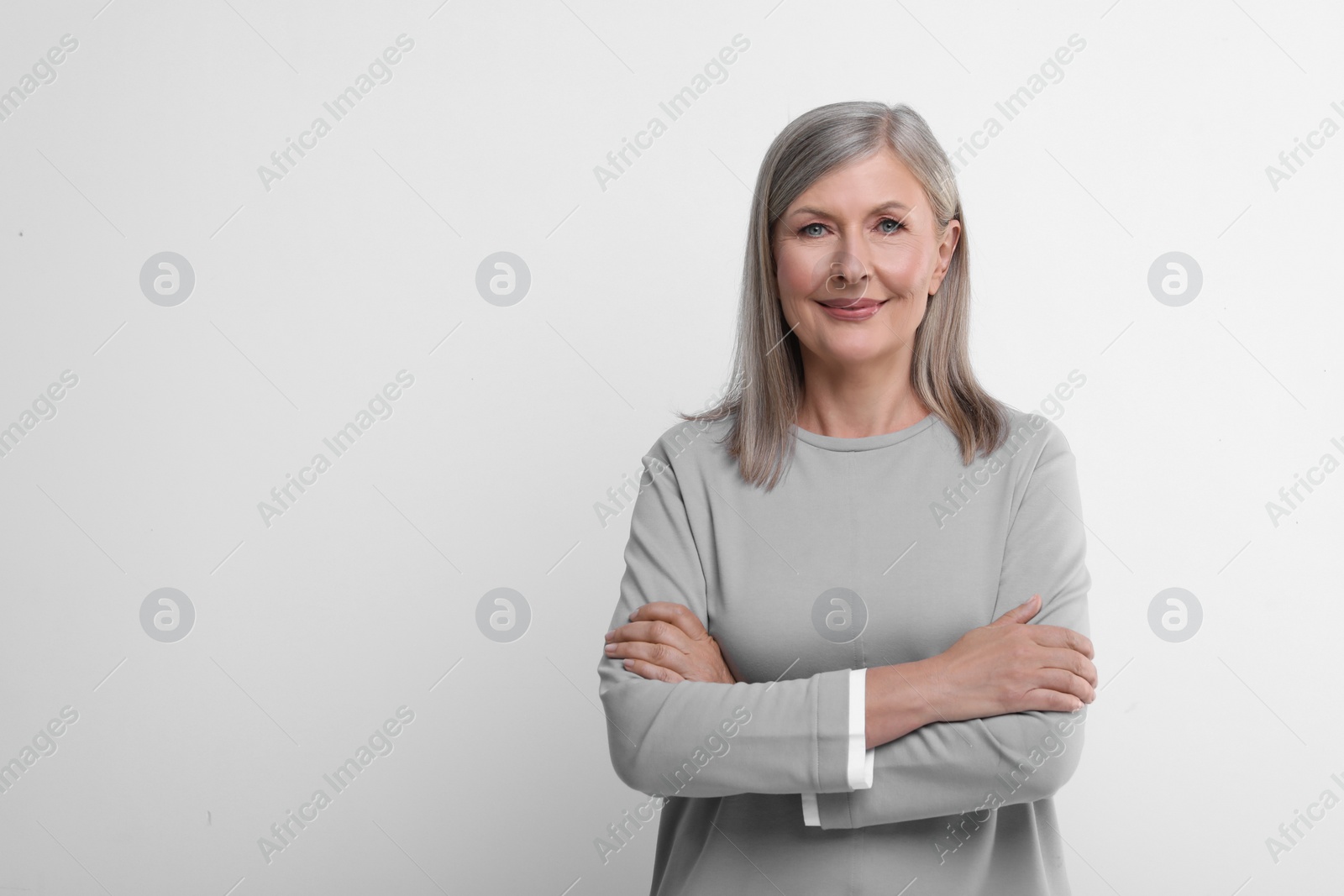 Photo of Portrait of beautiful senior woman on white background. Space for text
