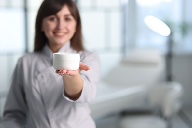 Cosmetologist with cosmetic product in clinic, selective focus. Space for text