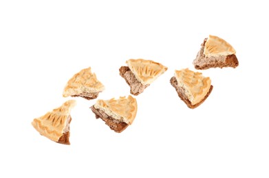 Photo of Pieces of tasty sandwich cookie with cream on white background