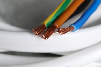 Colorful electrical wires on blurred background, closeup