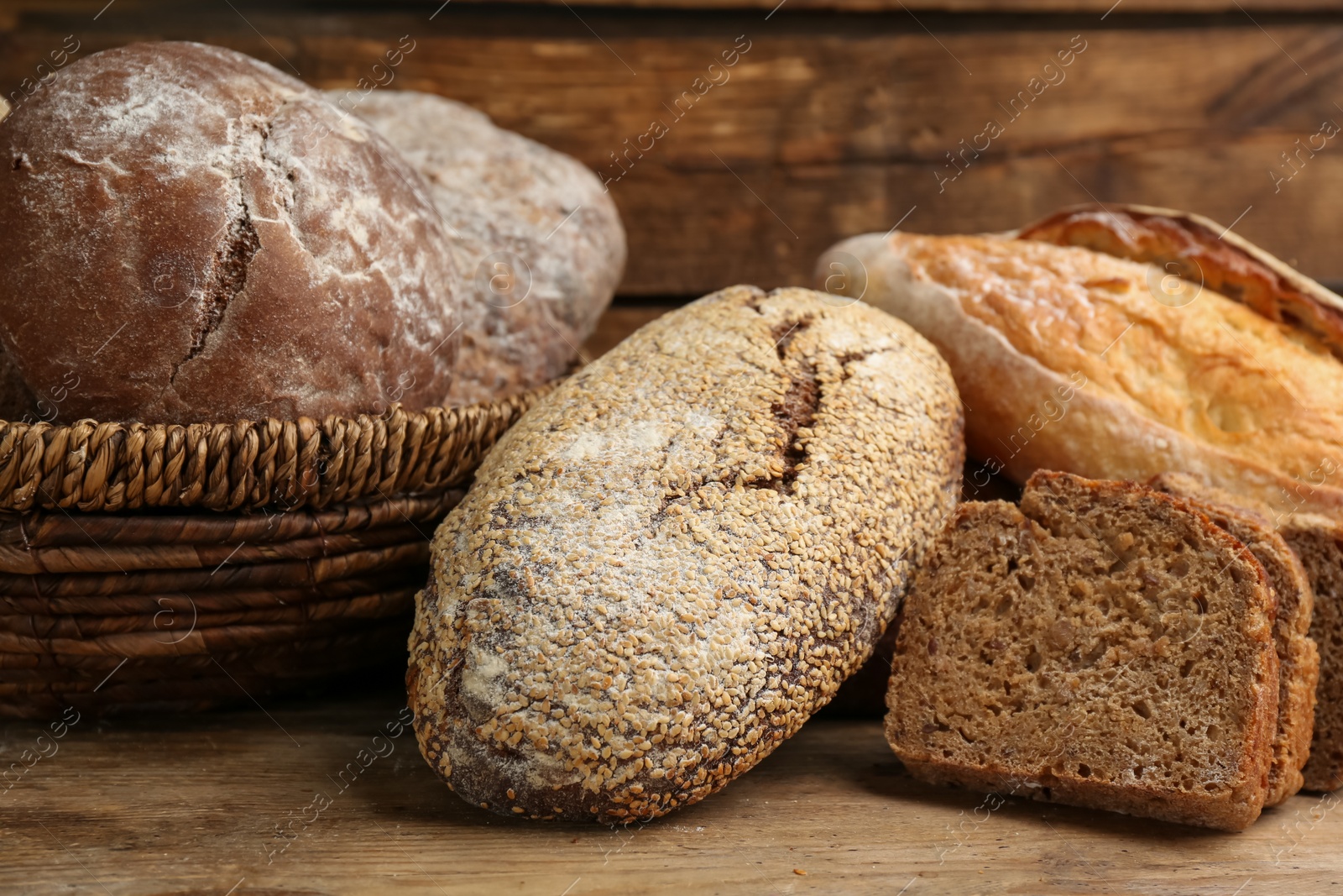 Photo of Different kinds of fresh bread on wooden table