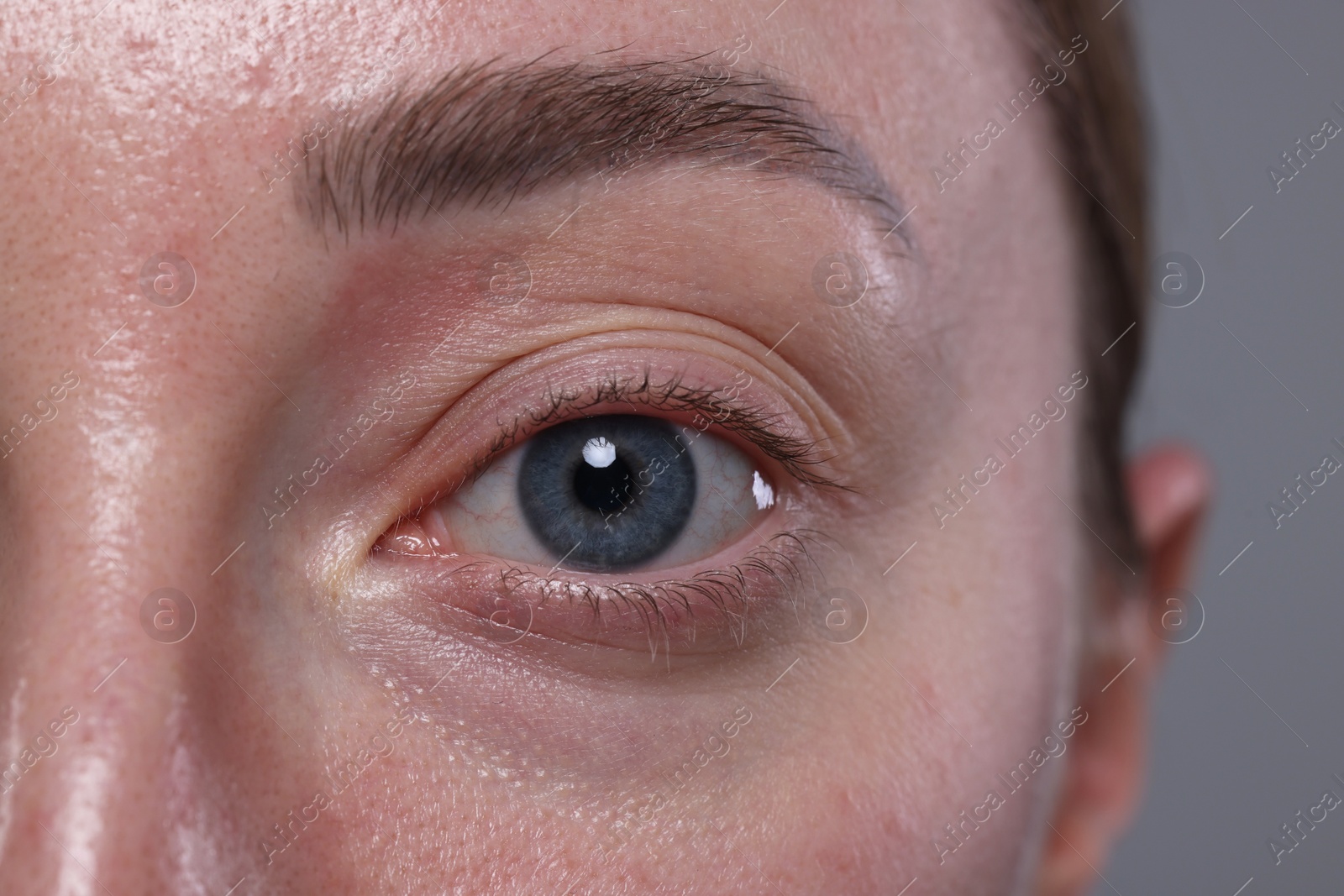 Photo of Closeup view of woman with beautiful eyes on grey background