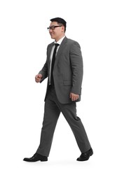 Businessman in suit walking on white background