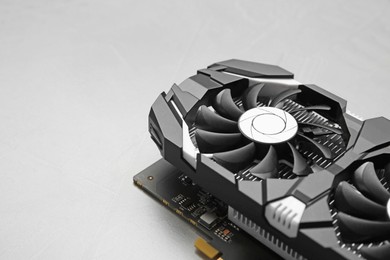 Photo of Computer graphics card on gray textured background, closeup. Space for text