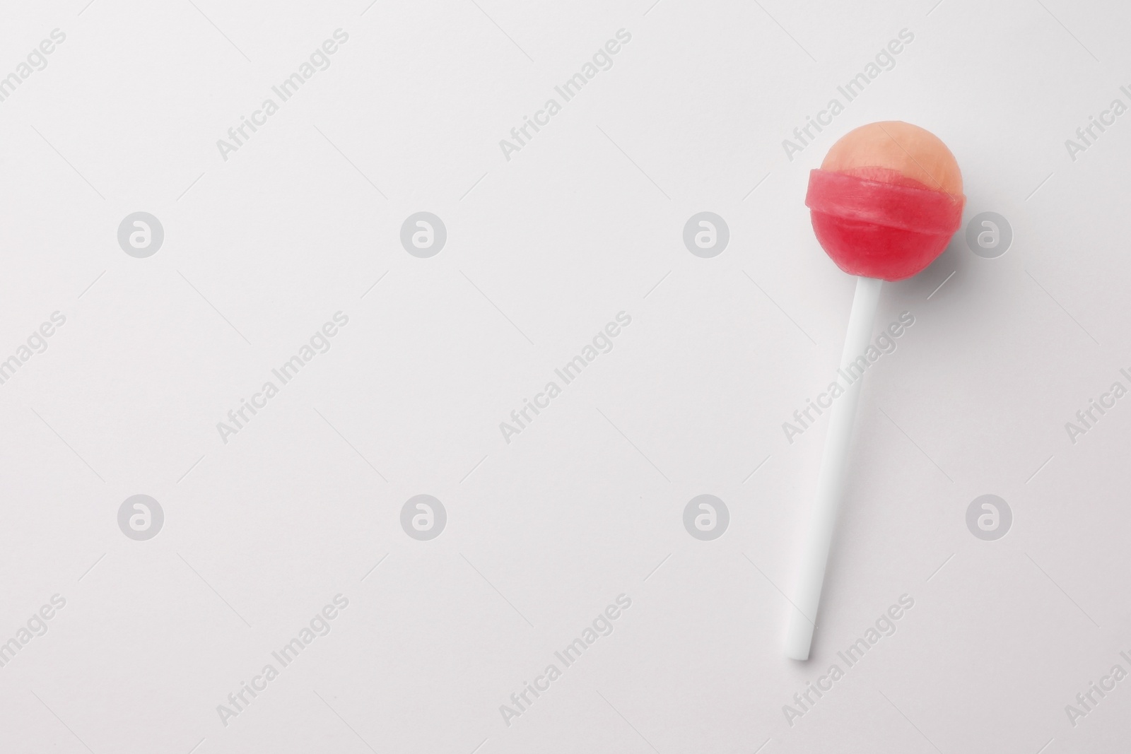 Photo of Tasty lollipop on white background, top view. Space for text