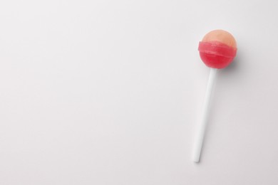 Tasty lollipop on white background, top view. Space for text