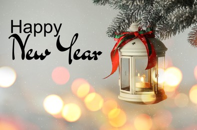 Image of Happy New Year. Christmas lantern with candle hanging on fir tree branch against light background.