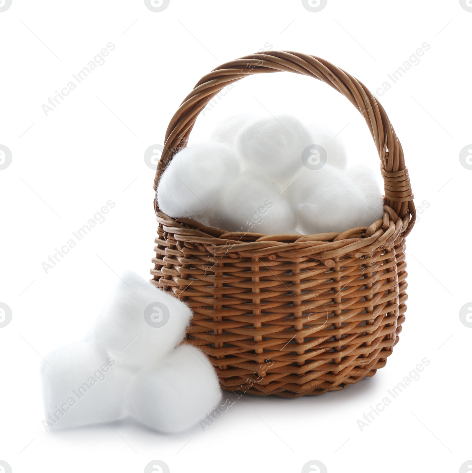 Photo of Wicker basket and cotton balls on white background