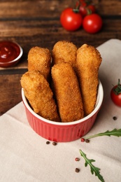 Photo of Bowl of cheese sticks on table, closeup