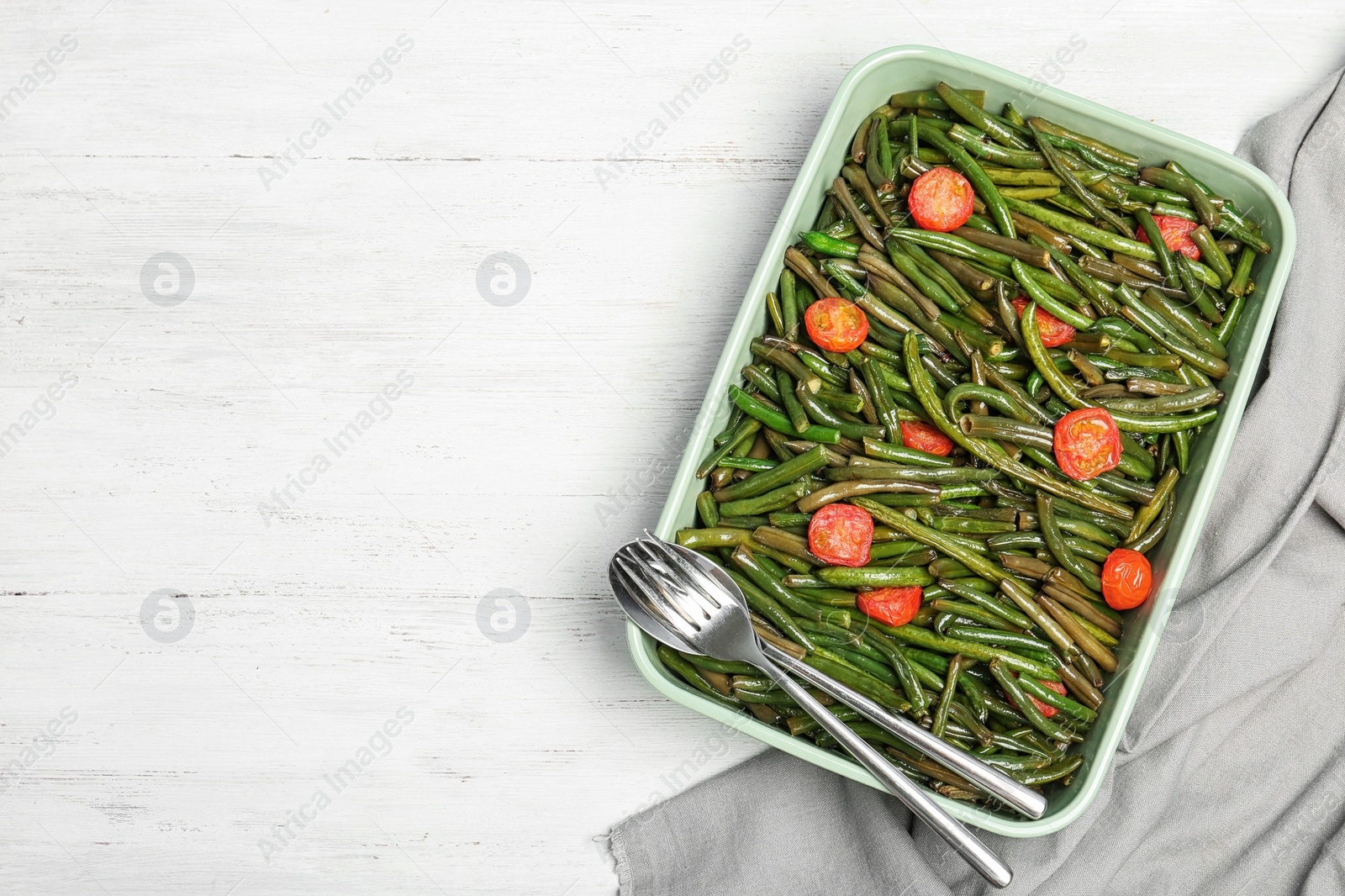 Photo of Dish with tasty green beans and tomatoes on table, top view