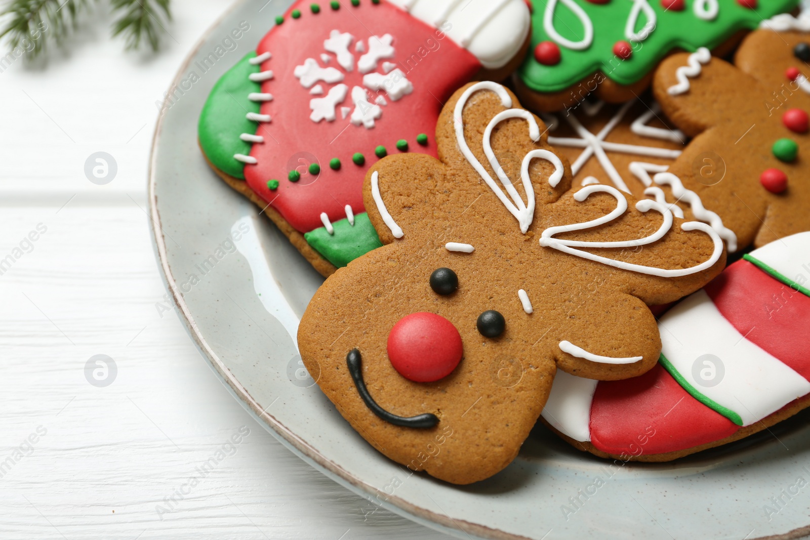 Photo of Tasty homemade Christmas cookies on white wooden table, closeup