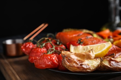 Tasty cooked salmon and vegetables served on table, closeup. Healthy meals from air fryer