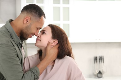 Photo of Dating agency. Happy couple spending time together in kitchen, space for text