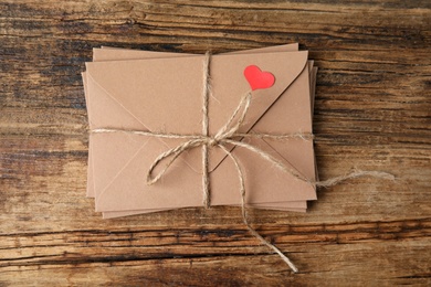 Stack of envelopes on wooden table, top view. Love letters