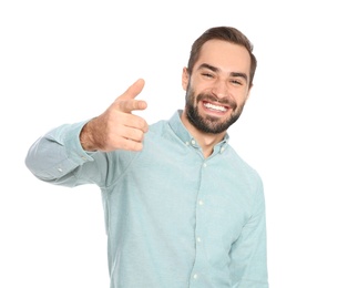 Portrait of young man laughing on white background