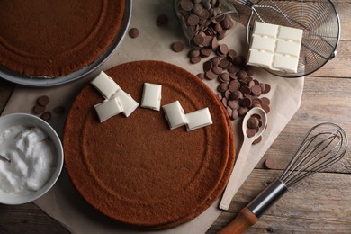 Photo of Ingredients for delicious homemade layer cake preparing on wooden table, flat lay