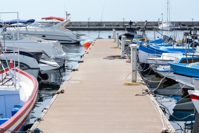 Beautiful view of city pier with moored boats on sunny day